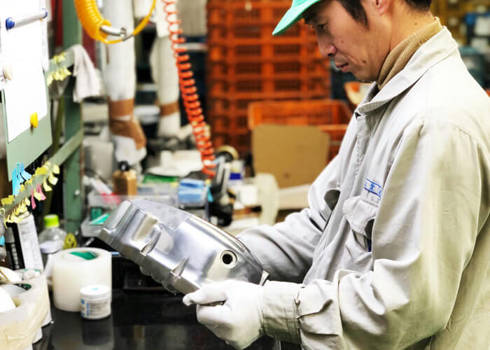 三陽工業で研磨の仕事に携わっている辻野将英さんの作業中風景